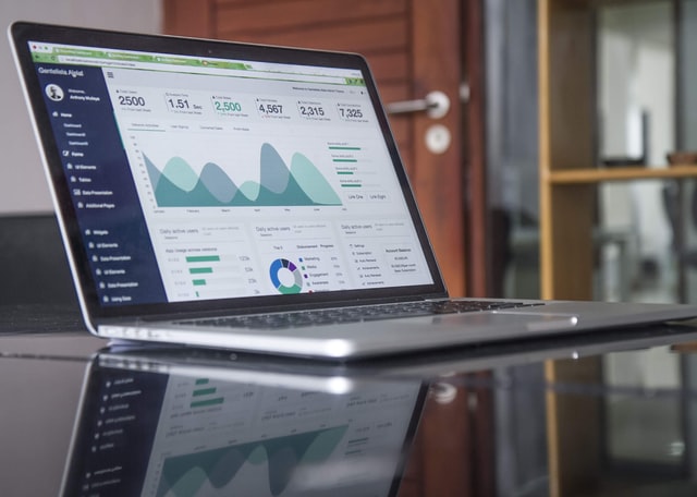 laptop showing graphs and charts on the screen